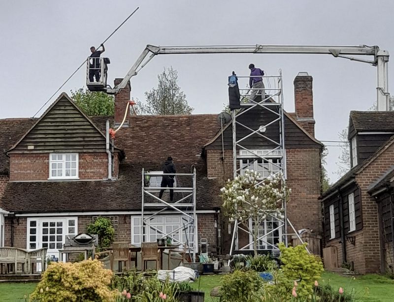 The Moss Cleaners using cherry picker and scaffolding to clean roof safely and professionally in Cinderford, Gloucestershire